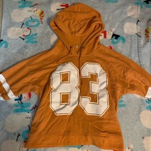 Burnt orange pullover with number 83 on it
